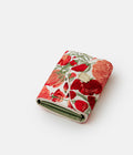 Red, White & Green hand-embroidered wallet from the AGNESTOTH Poppy collection — shown open, from the side